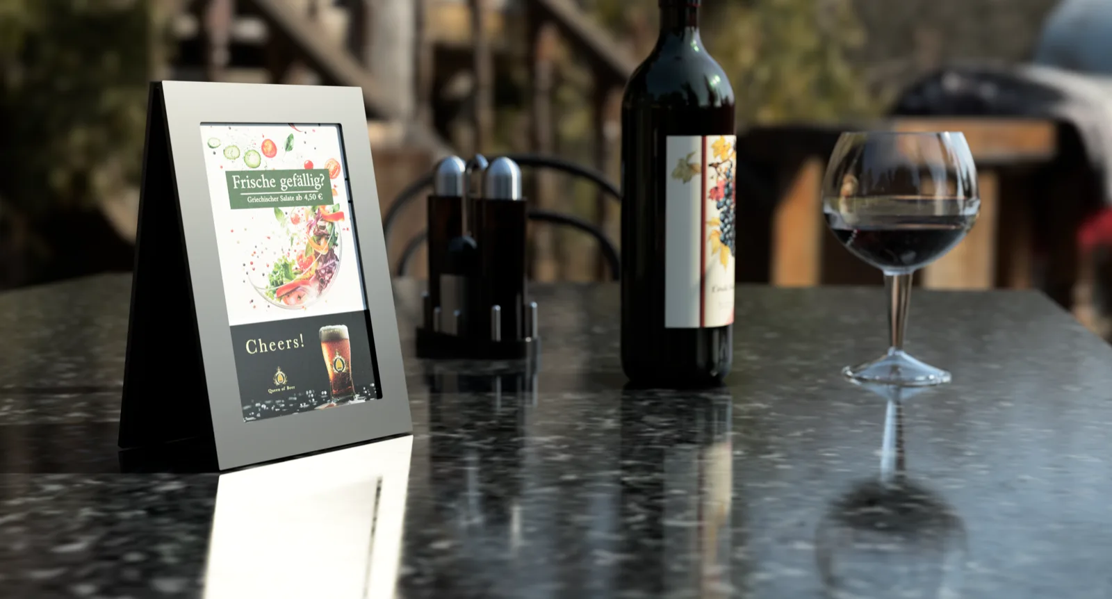 Dinio wireless e-paper display on an outdoor patio table